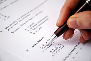 Person taking an exam, selecting answers from multiple-choice options labelled A, B, C, D.