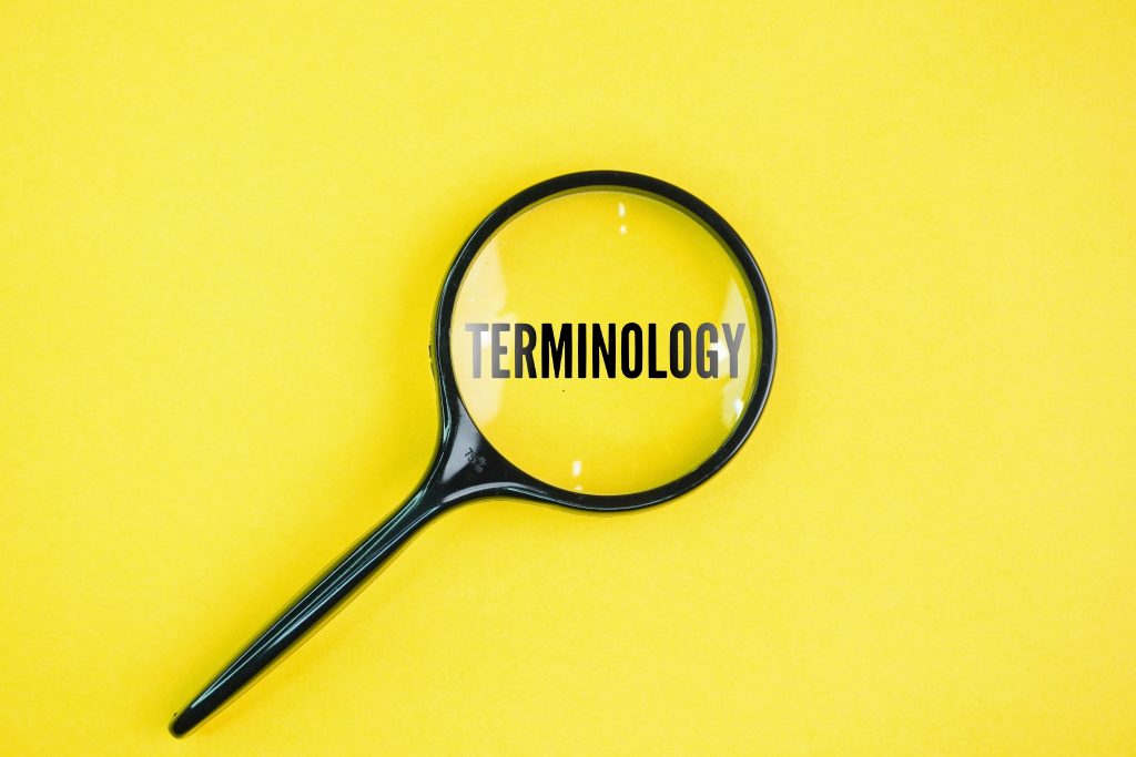 Magnifying glass highlighting the word “Terminology” on a yellow background.