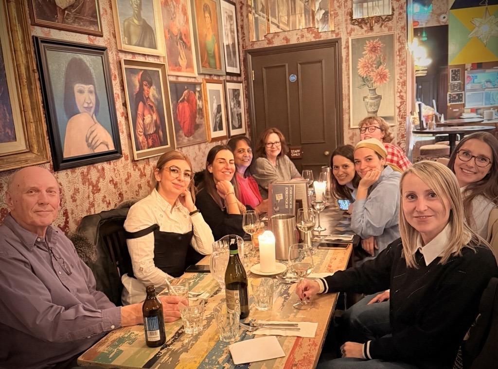 Comms Multilingual team celebrating our 23rd anniversary together over dinner.