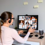 Professional interpreter facilitating a multilingual video meeting remotely